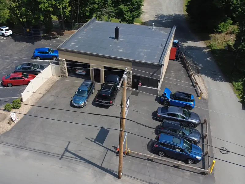 V-Tech Auto Services shop, its garage bays and parking lot, seen from a drone